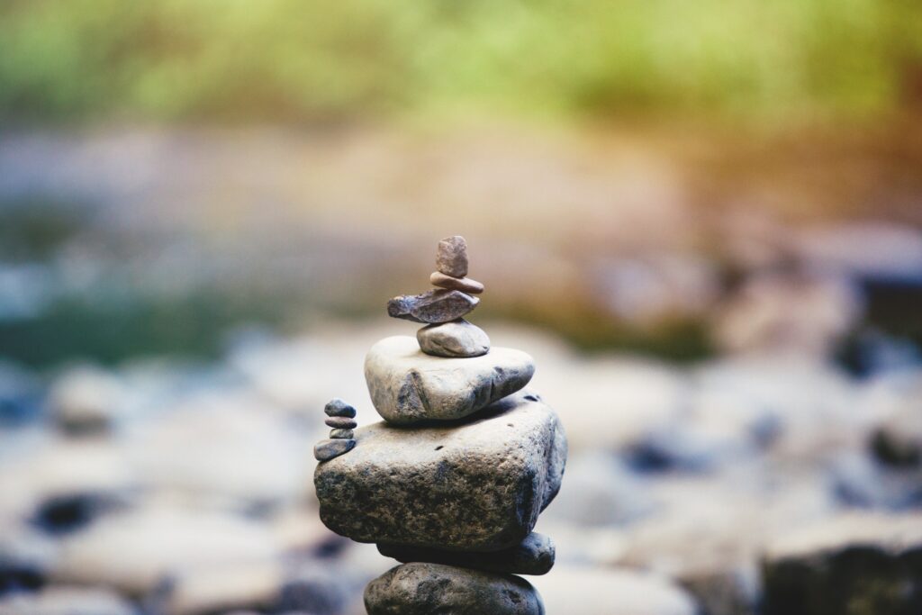 Balancing your priorities to achieve your goals. Rocks on top of each other.